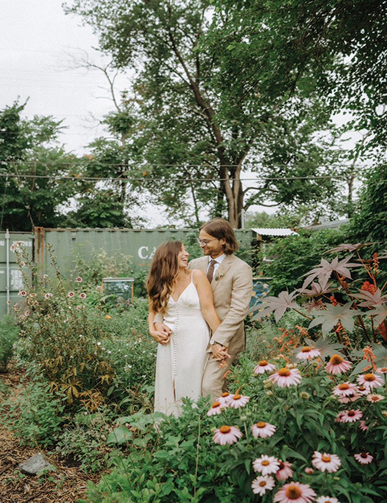 Wedding couple in garden standing for wedding photos